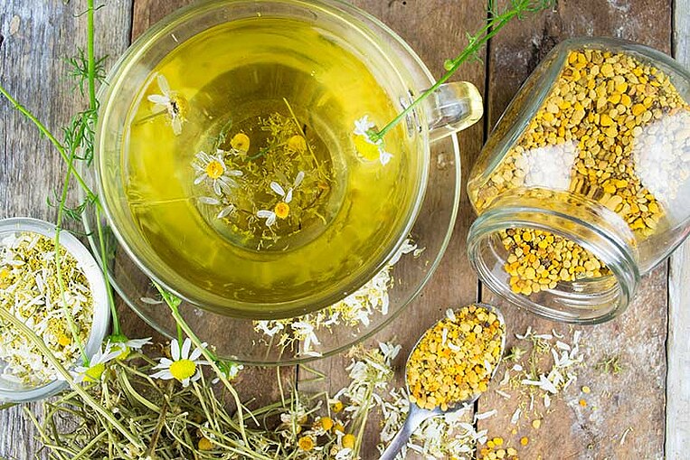 Brewed chamomile tea and dried chamomile flowers. Brewed chamomile tea and dried chamomile flowers.