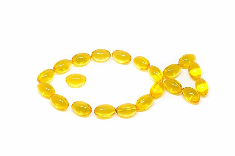 Mit Kapseln gelegtes Symbol eines Fisches Mit Kapseln gelegtes Symbol eines Fisches